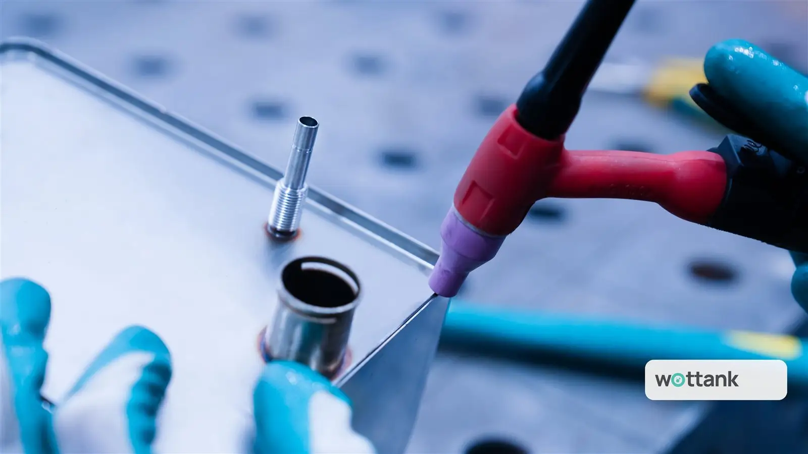 Hand TIG welding torch finishing a port fitting on a stainless panel